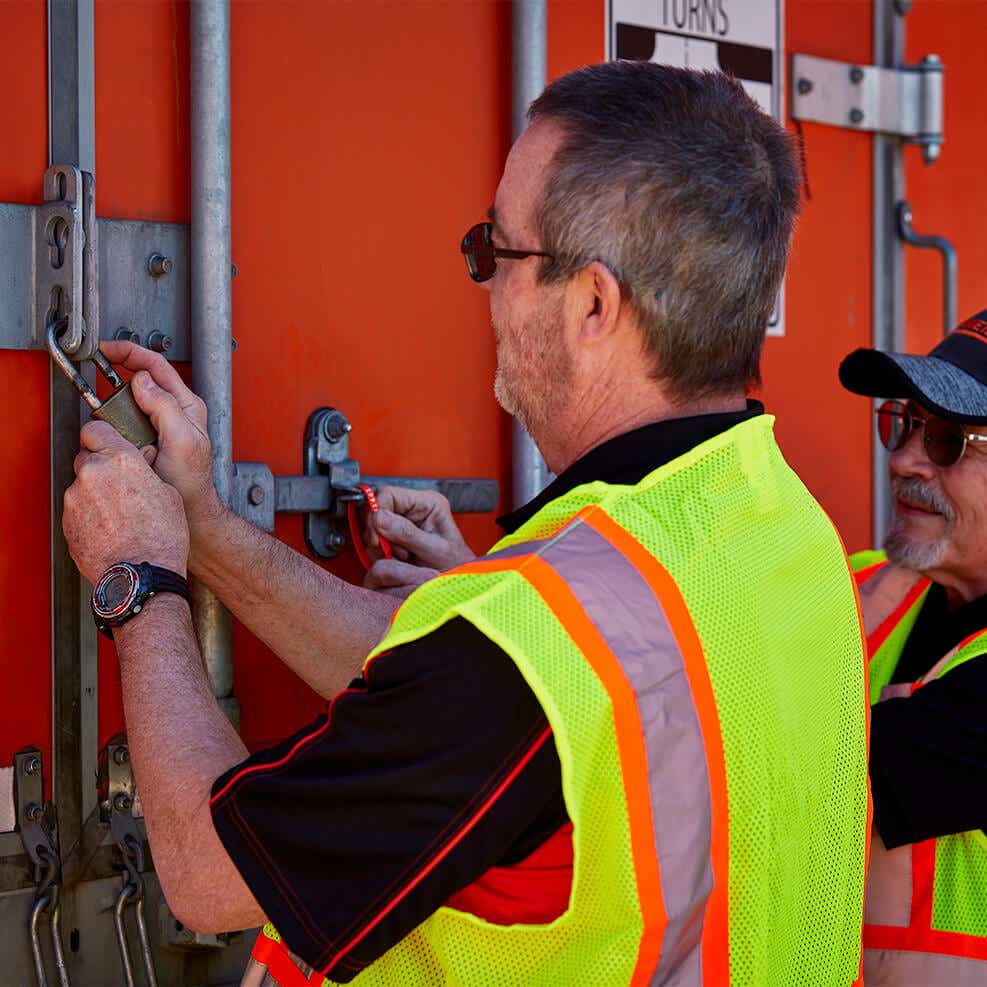 image of team drivers securing cargo for shipping