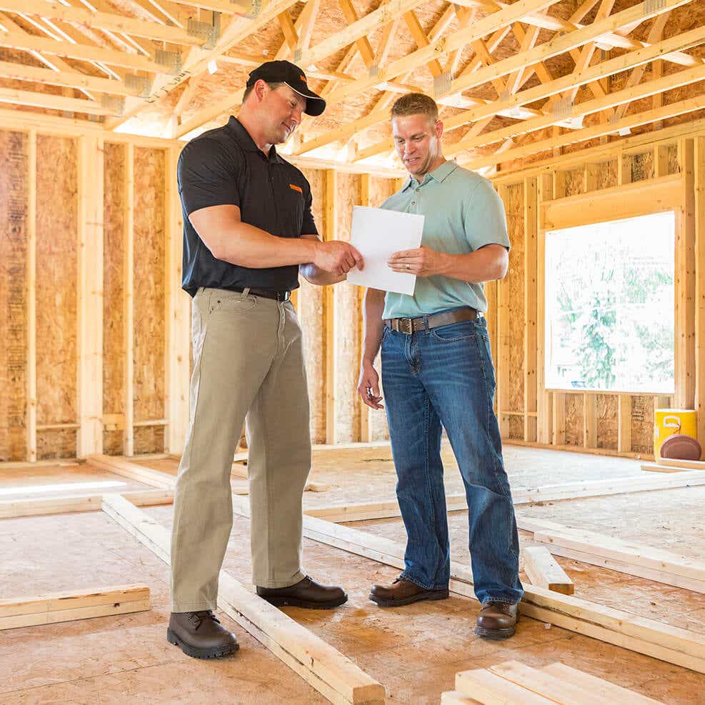 men reviewing paperwork at a construction site